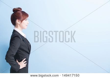 business woman is smile and arms akimbo with isolated on blue background asian