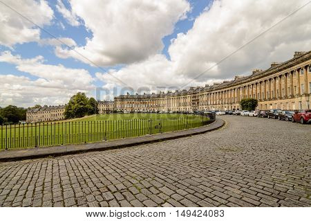 Bath UK - August 15 2015: The famous Royal Crescent building in Bath. Sunny day with blue sky and white clouds.