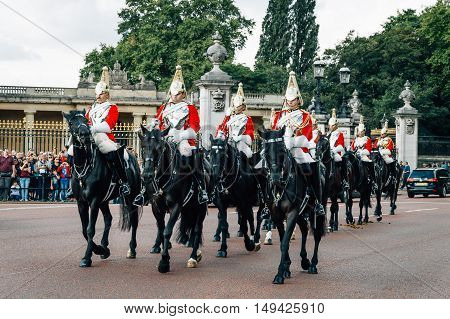London UK - August 19 2015: Queen's Guards cavalry parade during traditional Changing of the Guards ceremony at Buckingham Palace. This is one of the most popular tourist attractions in London.