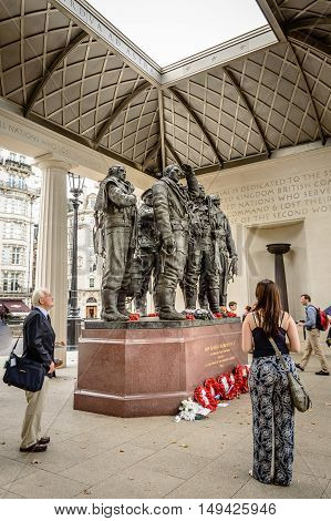 London UK - August 19 2015: People at The Bomber Command Memorial commemorates the 55573 who died while serving in the Bomber Command during the Second World War.