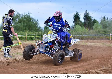 Unidentified Racer Rides A Quad Motorbike.
