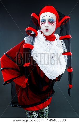 Close up portrait with cheerful clown in a vintage style with a typical makeup