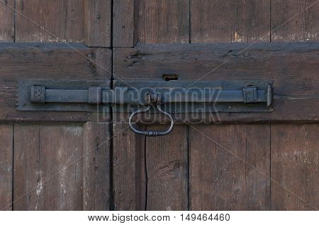 part of wooden door with doorhandle and keyhole