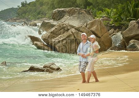 Happy elderly couple rest at tropical beac