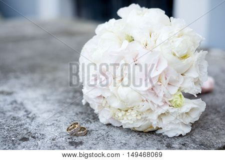 wedding details of a ring white bouquet