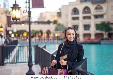 Young beautiful muslim woman shopping in the city.