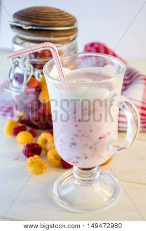 milkshake with berries fresh raspberries on a white background