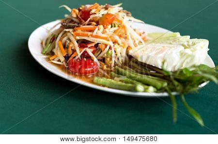 Papaya Salad Thai style (Som tum ) serve with fresh grees vegetable