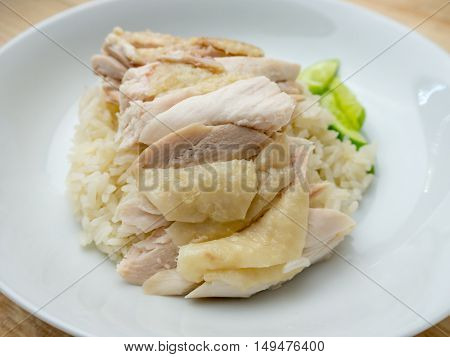 Hainanese chicken rice in the white plate