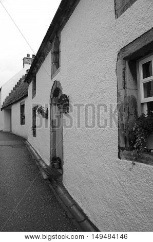 An exterior view of medieval buildings in a narrow street in Culross