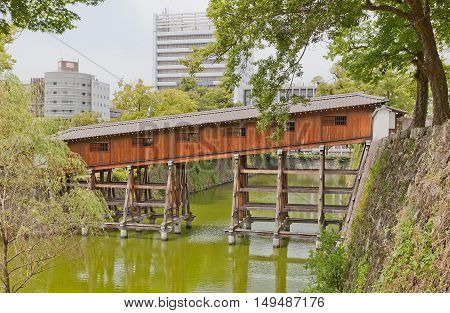 WAKAYAMA JAPAN - JULY 24 2016: Ohashiroka covered bridge of Wakayama castle Japan. Spans Ninomaru and Nishinomaru baileys. Reconstructed in 2006