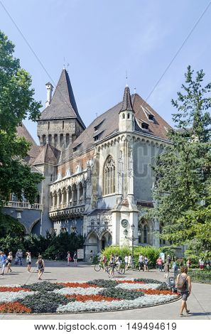 BUDAPEST, AUGUST 9: Tourists enjoying the beautiful weather visit Vajdahunjad Castle on August 9, 2015 in Budapest, Hungary. Vajdahunyad Castle is located in the City Park.