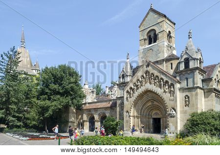 BUDAPEST, AUGUST 9: Tourists enjoying the beautiful weather visit Chapel in castle Vajdahunjad on August 9, 2015 in Budapest, Hungary. Vajdahunyad Castle is located in the City Park.