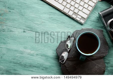 office table with notebook computer keyboard and coffee mug. Copy space.