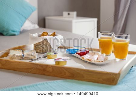 Breakfast tray in bed with delicious food
