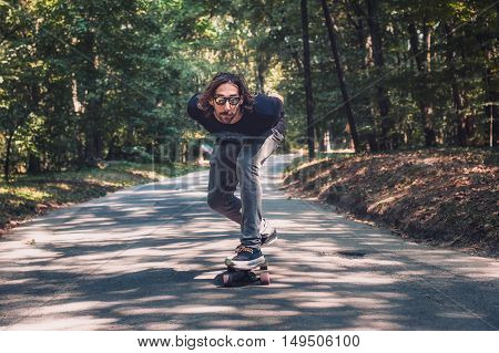 Longboard Skating - Skateboarder Ride A Longboard Through The Forest