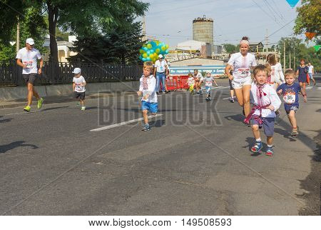 DNEPR ULRAINE - AUGUST 24, 2016: Kids running in Vyshyvanka Run during Independence Day local activity in Dnepr Ukraine at August 24 2016