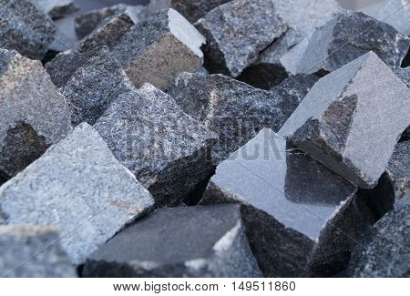Pile of grey cube granite stones, texture