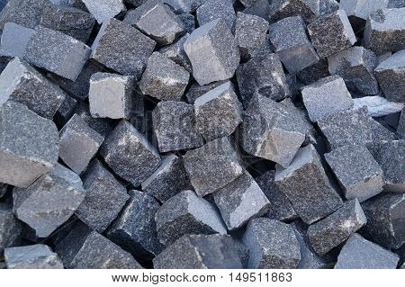 Pile of grey cube granite stones, texture