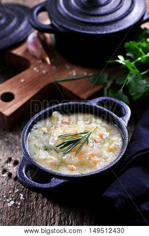 Thick soup of corn grits with potatoes, carrots, garlic, dill and coriander