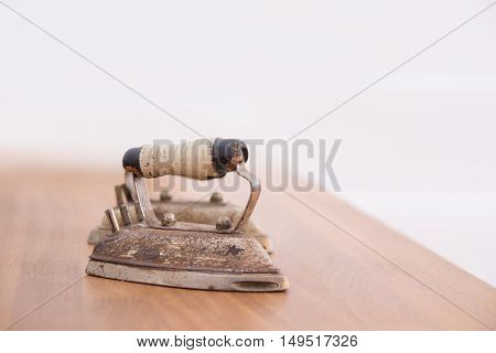 Small antique iron over naturally blurred background