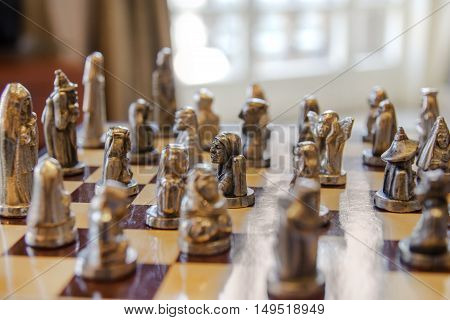 Detail of an antique chessboard with carved figures