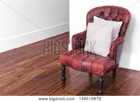 Classic luxury red leather armchair on wood floor