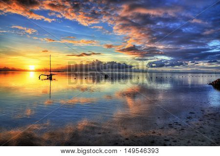 Amazing colorful sunset on the beach of Moorea French Polynesia. HDR (High dynamic range) picture.
