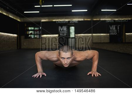 a man pushed from the floor in the gym. Concept workout healthy lifestyle sport