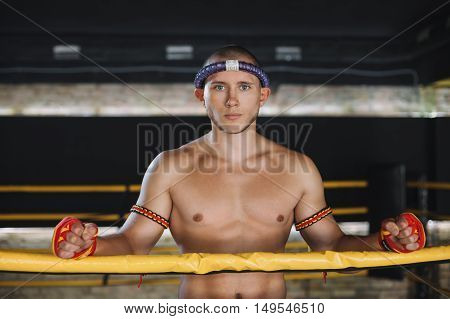 Man Fighter Muay Thai Stand in the ring