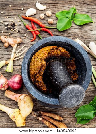 Assortment Of Thai Food Cooking Ingredients And Paste Of Thai Popular Food Red Curry  With Mortar An