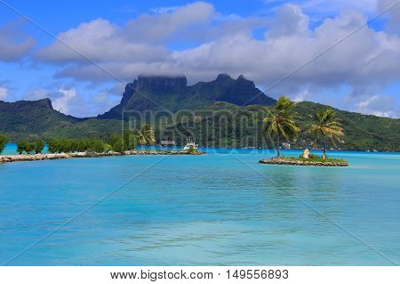 View from Bora Bora airport. Beautiful palms mountains and blue sea. French Polynesia South Pacific Ocean.