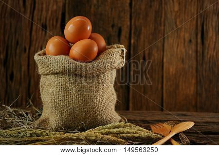 Fresh eggs on wooden background from farm and prepare for cook in kitchen room, Organic food and clean food for healthy, Eggs from farm to the market for raw material to cooking by chef in restaurant.