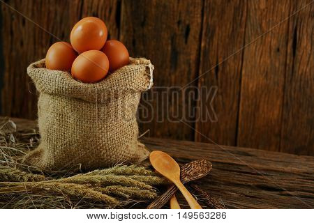 Fresh eggs on wooden background from farm and prepare for cook in kitchen room, Organic food and clean food for healthy, Eggs from farm to the market for raw material to cooking by chef in restaurant.