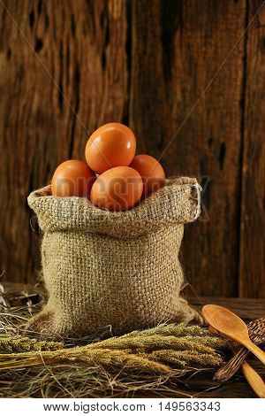 Fresh eggs on wooden background from farm and prepare for cook in kitchen room, Organic food and clean food for healthy, Eggs from farm to the market for raw material to cooking by chef in restaurant.
