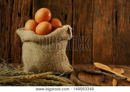 Fresh eggs on wooden background from farm and prepare for cook in kitchen room, Organic food and clean food for healthy, Eggs from farm to the market for raw material to cooking by chef in restaurant.