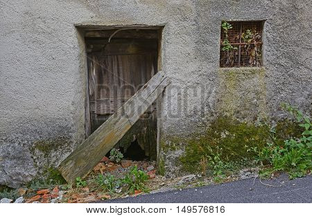 An old wooden door in a derelict building the village of Oblizza Friuli north east Italy.