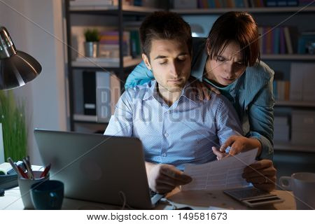 Young Couple Checking Bills At Night