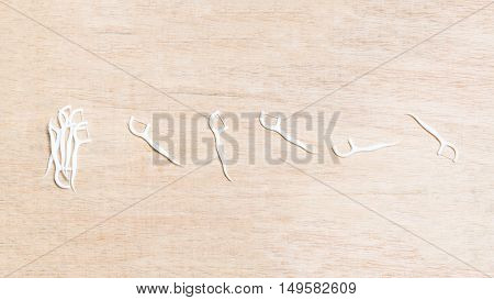 Oral Device : Dental Flossers On Wooden Background