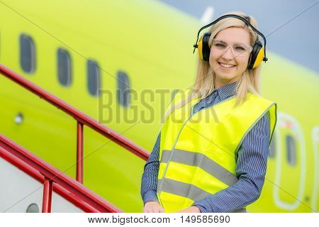 Aircraft engineer with CB radio standing in front of a commercial airliner