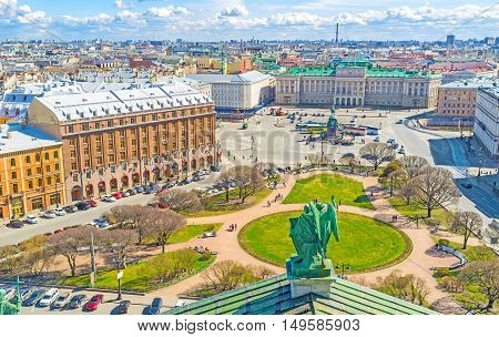 The rooftop of St Isaac's Cathedral is the best place to enjoy the ensemble of St Isaac's Square with green park monument of Tsar Nicholas I Mariinsky Palace historic hotels and mansions St Petersburg Russia.