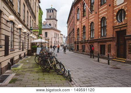 September, 22th, 2015 - Latin Quarter in Copenhagen, Denmark. Old scandinavian houses, restaurants, parked bicycles and university building.