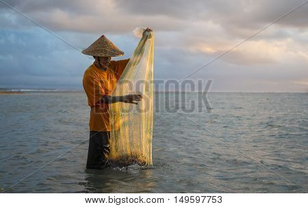 Bali, Indonesia, September, 2016: old fisherman in a sea in Bali Indonesia