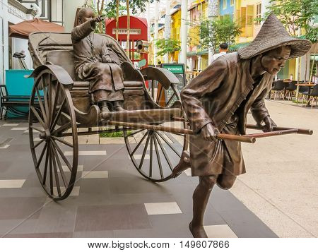 SINGAPORE, REPUBLIC OF SINGAPORE - JANUARY 09, 2014: Sculptures of Chinese rickshaw in the Telok Ayer area, Singapore