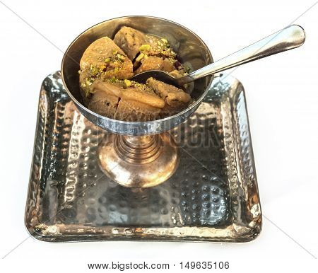 A photo of kulfi, traditional Indian ice cream, in a typical bowl, isolated on white. Selective focus on the dessert