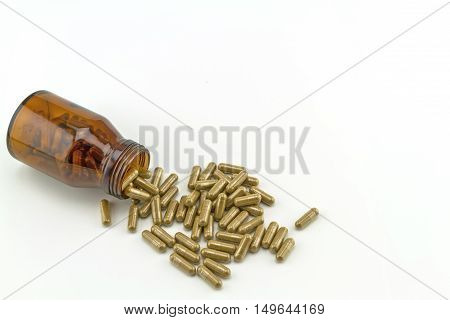 Colorful drug pill in black bottle on white background