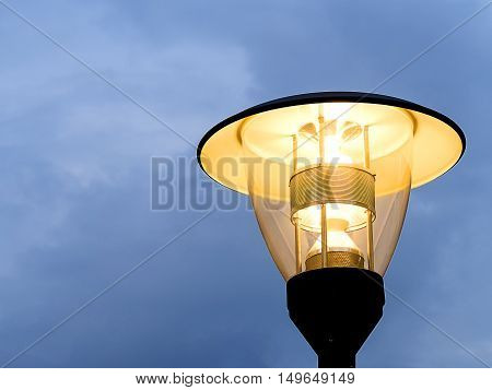 The LED lamp on the electricity pole with the blue sky. The environment conservation by using LED street lamp