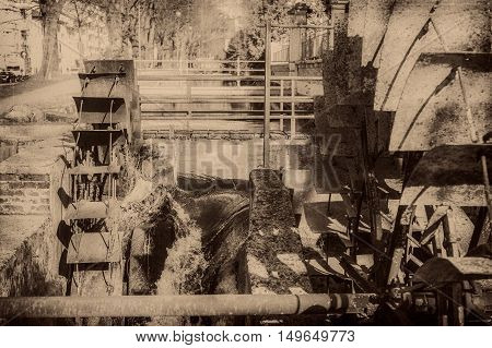 Old Wheels Of A Watermill. Vintage Style Picture. Adding Grain To Give An Old Photo Effect.