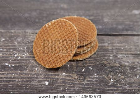 Dutch cookie stroopwafels on brown wooden background