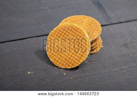 Dutch cookie stroopwafels on black wooden background